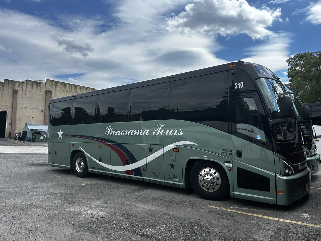 Green 40 Passenger Luxury Coach with tinted windows