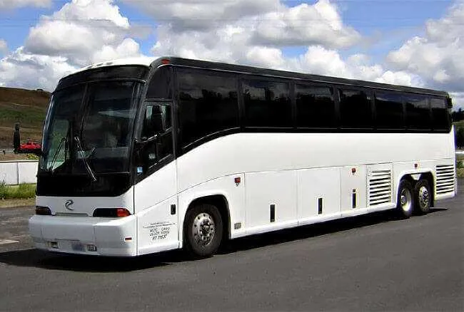White 30 Passenger Charter Bus with tinted windows