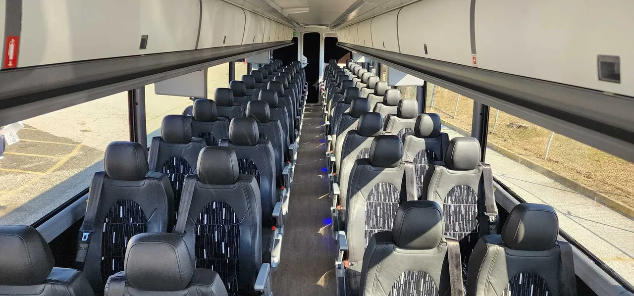 30 Passenger Charter Bus cabin view with overhead parcel racks