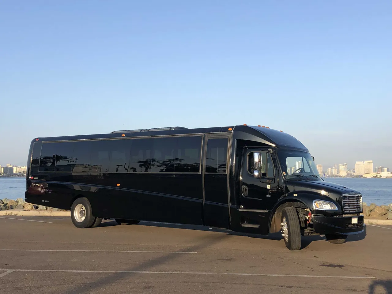 Black Executive Mini-Coach exterior angle with tinted windows