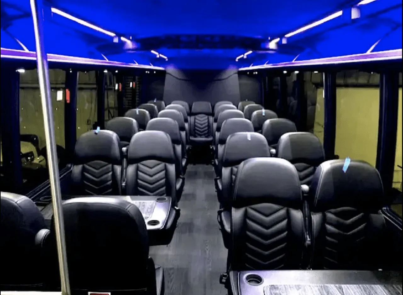 Ford Mini-Coach cabin view with passenger tables, cup holders and LED ceiling lighting