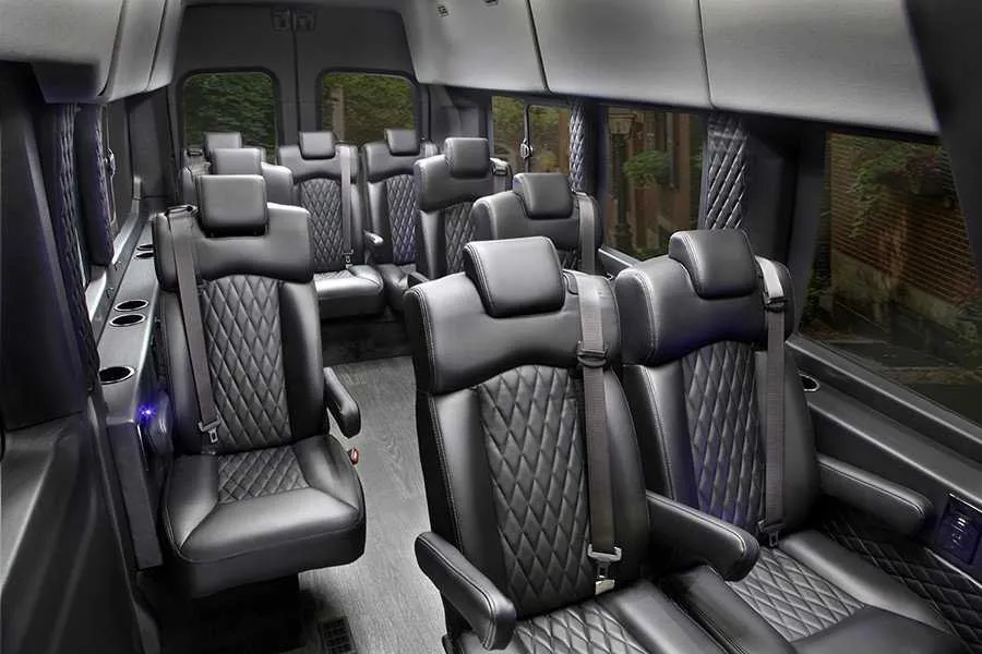 Ford Transit Executive Shuttle cabin view with captain's chairs and cup holders
