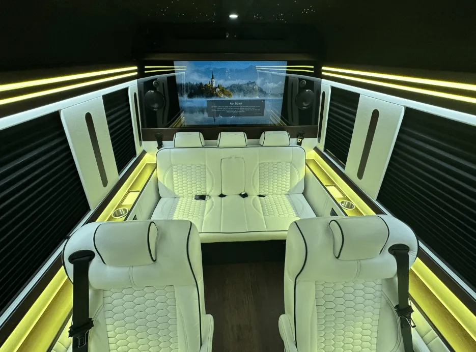 Luxury Mercedes-Benz Sprinter cabin view, angle 6 with captain's chairs, window shades and LED accent lighting