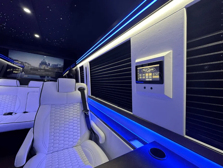 Luxury Mercedes-Benz Sprinter cabin view with captain's chairs, window shades and LED accent lighting