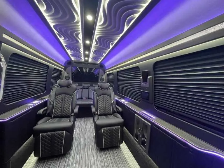 Luxury Mercedes-Benz Sprinter cabin view, angle 5 with captain's chairs, window shades and LED accent lighting