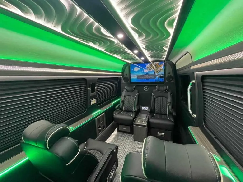 Luxury Mercedes-Benz Sprinter cabin view, angle 4 with captain's chairs, window shades and LED accent lighting