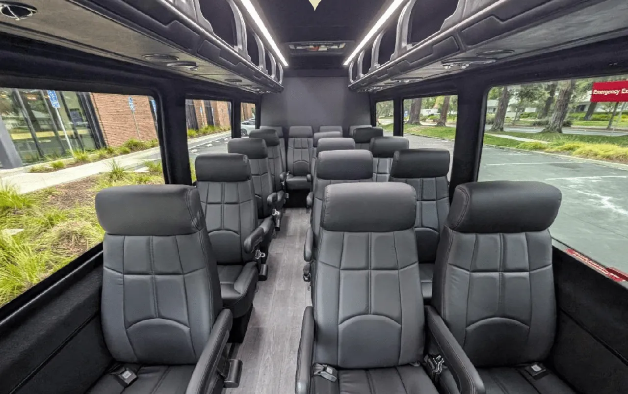 Mercedes-Benz Executive Sprinter Mercedes-Benz Executive Sprinter cabin view with captain's chairs, wood-look flooring and overhead parcel racks