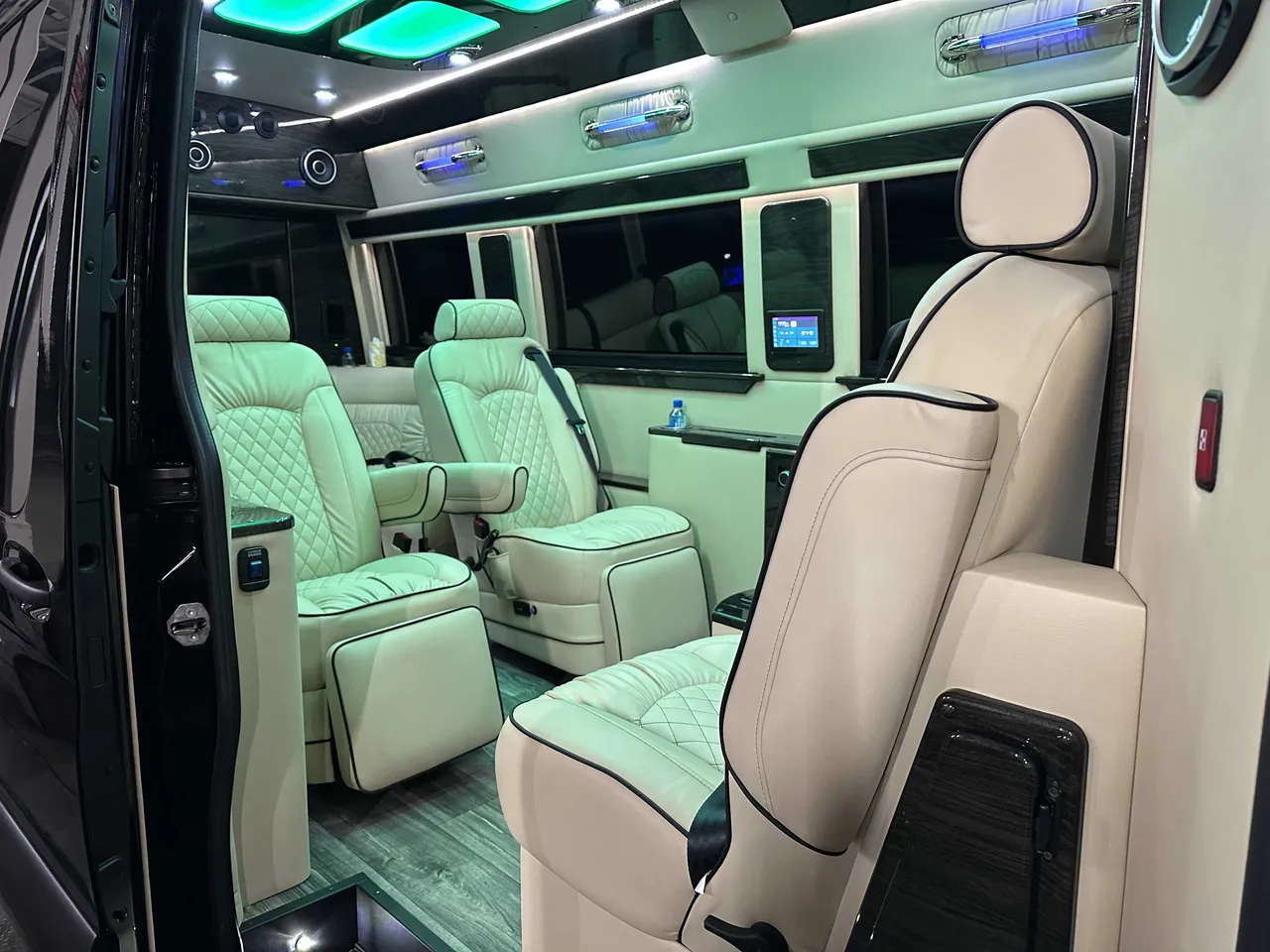 Mercedes-Benz Executive Sprinter cabin view with captain's chairs, LED accent lighting and LED ceiling lighting