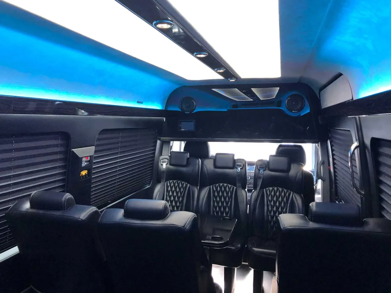 Mercedes-Benz Executive Sprinter cabin view, angle 4 with captain's chairs, window shades and LED ceiling lighting
