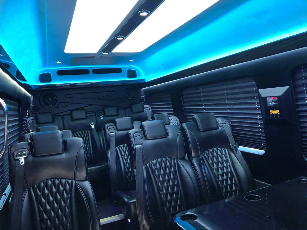 Mercedes-Benz Executive Sprinter cabin view, angle 3 with captain's chairs, passenger tables and window shades