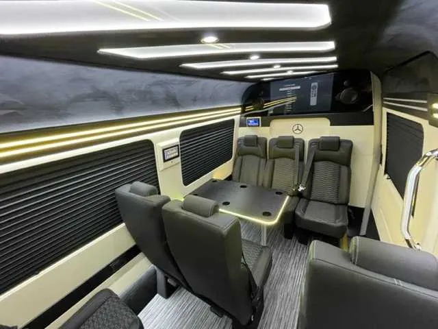 Mercedes-Benz Executive Sprinter Mercedes-Benz Executive Sprinter cabin view with passenger tables, window shades and LED accent lighting