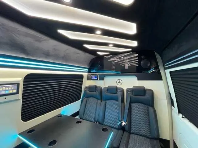 Mercedes-Benz Executive Sprinter cabin view with passenger tables, cup holders and window shades