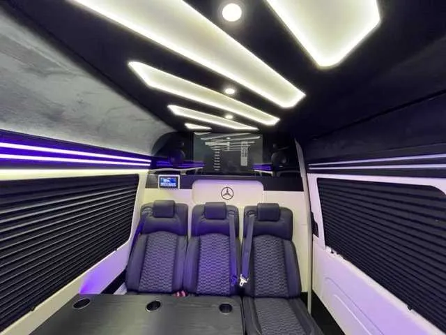 Mercedes-Benz Executive Sprinter cabin view, angle 4 with passenger tables, cup holders and window shades