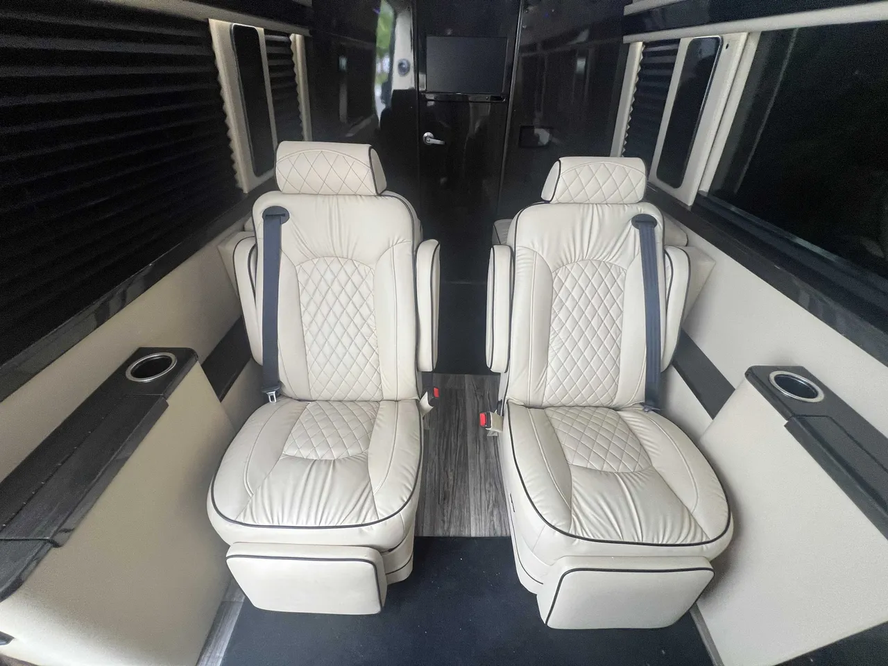 Mercedes-Benz Executive Sprinter cabin view with captain's chairs and window shades