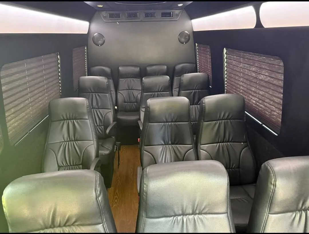 Mercedes-Benz Limousine Sprinter cabin view with captain's chairs, window shades and LED ceiling lighting
