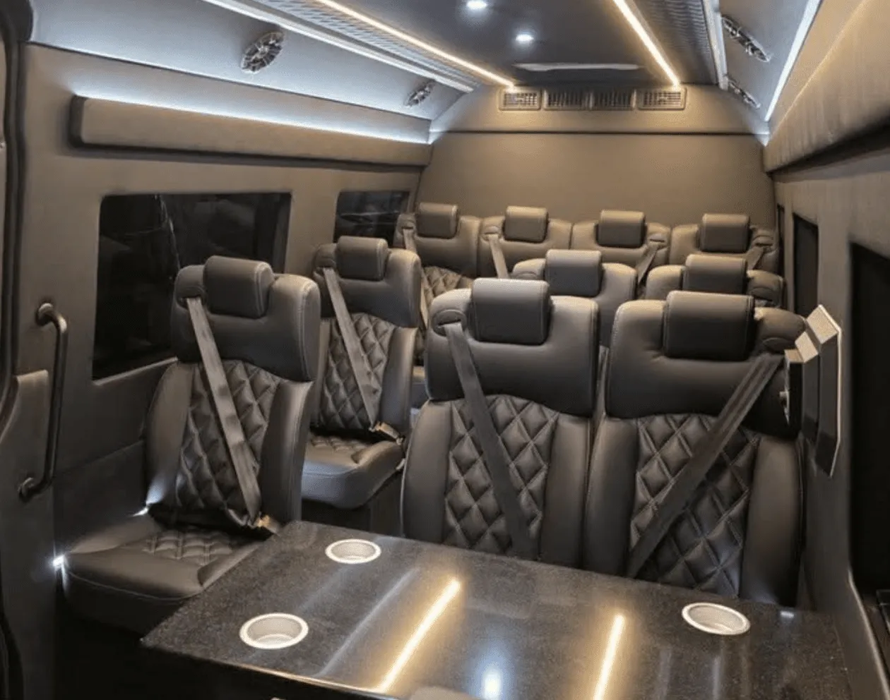 Mercedes-Benz Sprinter Executive cabin view with captain's chairs, passenger tables and cup holders