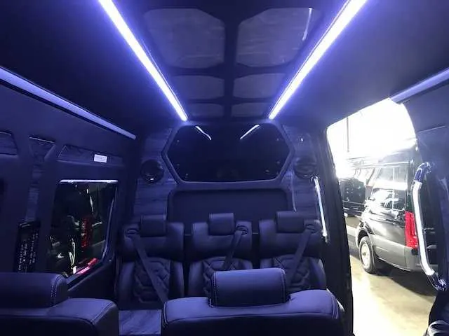 11 Passenger Mercedes-Benz Sprinter Luxury cabin view with LED ceiling lighting and grab handles and rails
