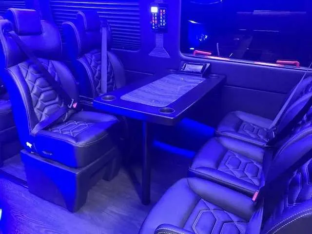 11 Passenger Mercedes-Benz Sprinter Luxury cabin view with captain's chairs, passenger tables and cup holders