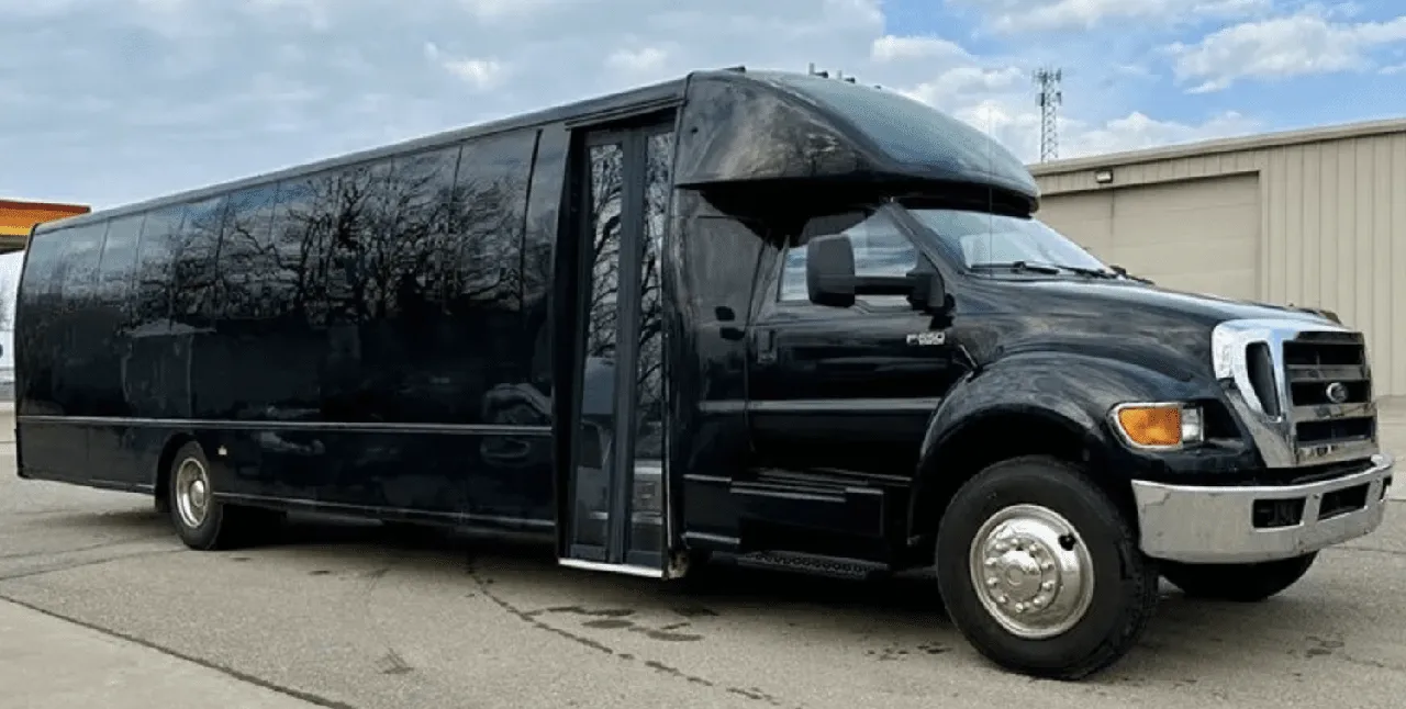 Black 30 Passenger Mini Coach with tinted windows