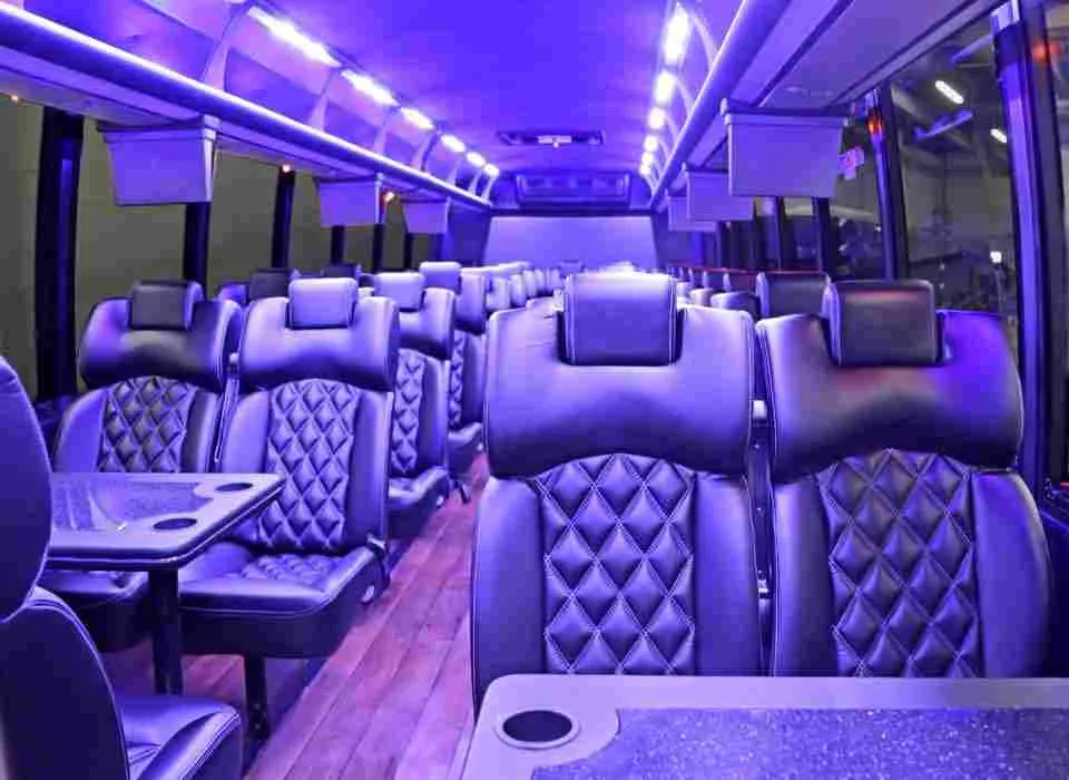 40 Passenger Mini Coach cabin view with passenger tables, cup holders and LED ceiling lighting