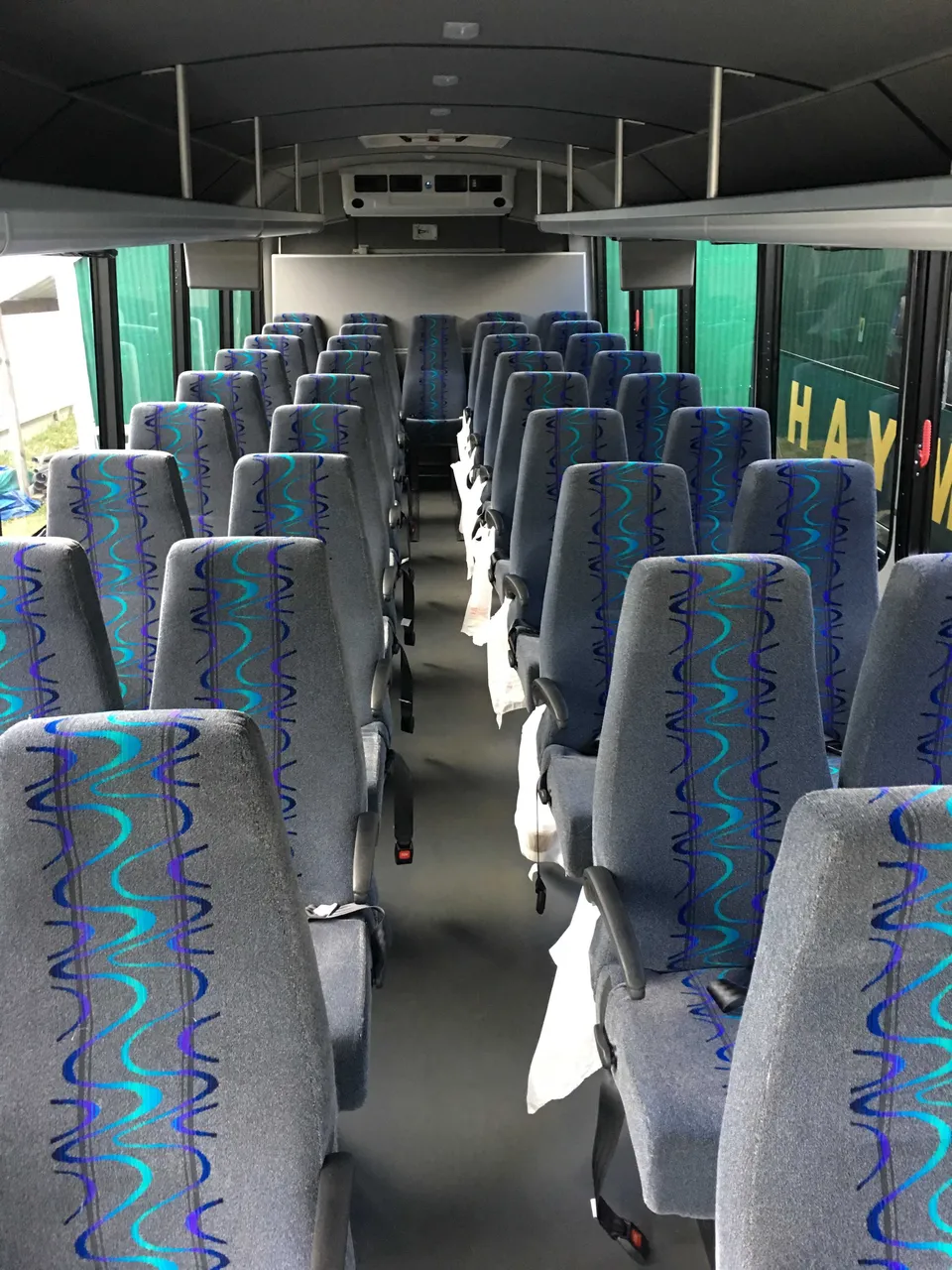 36 Passenger Mini Coach cabin view with overhead parcel racks