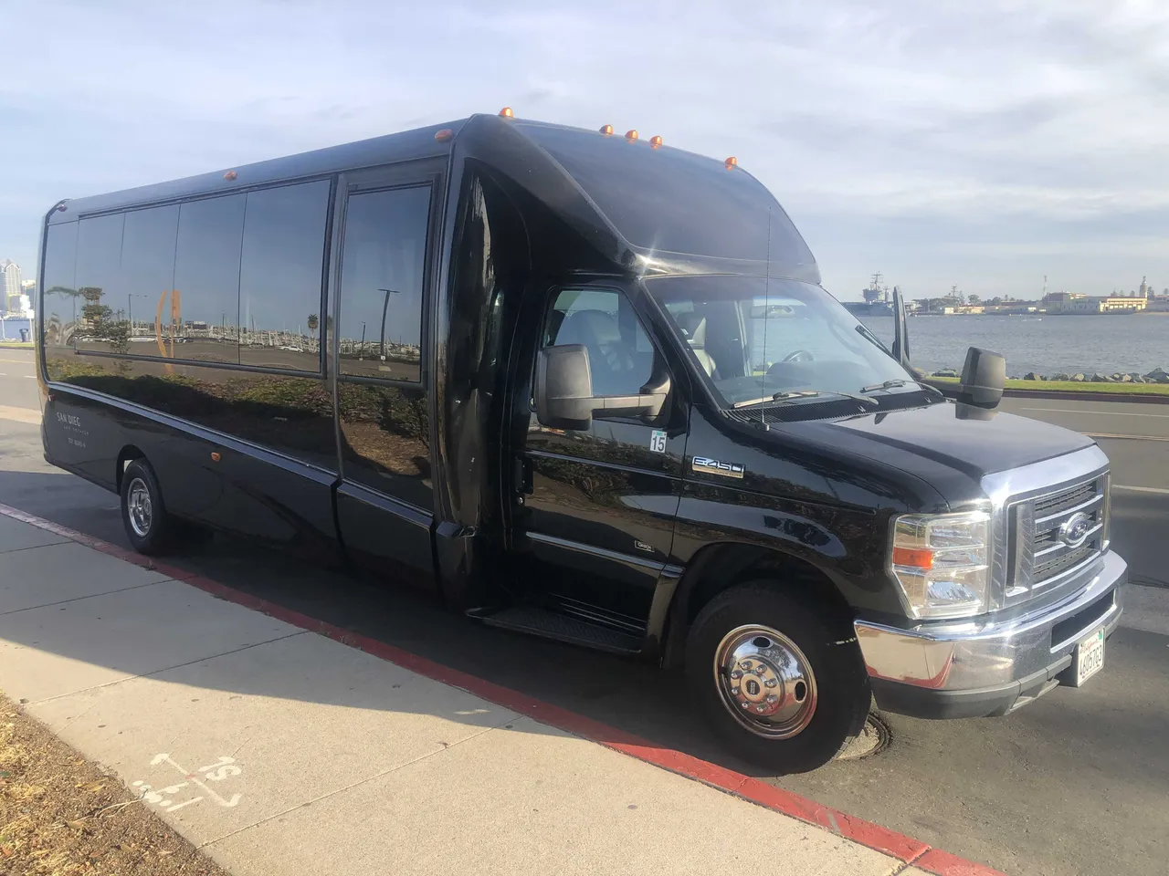 Black 21 Passenger Mini Coach exterior angle, angle 4 with tinted windows