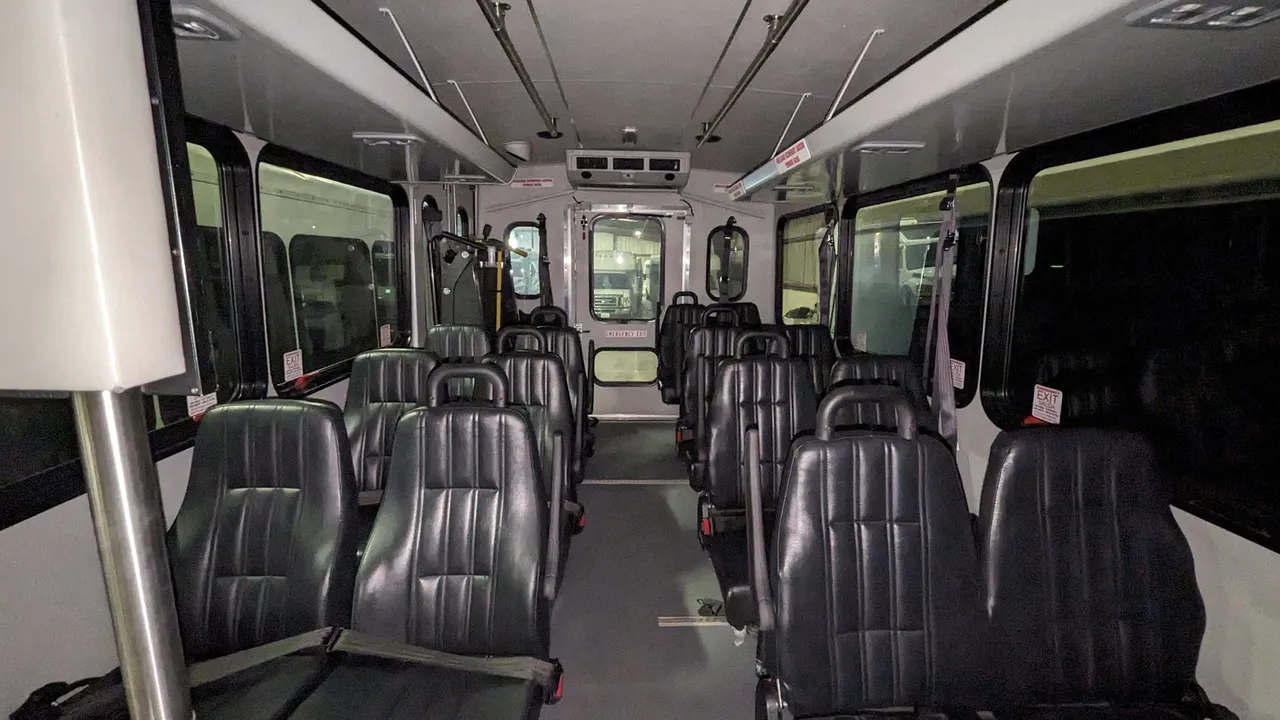 Mini Moto Coach cabin view with grab handles and rails