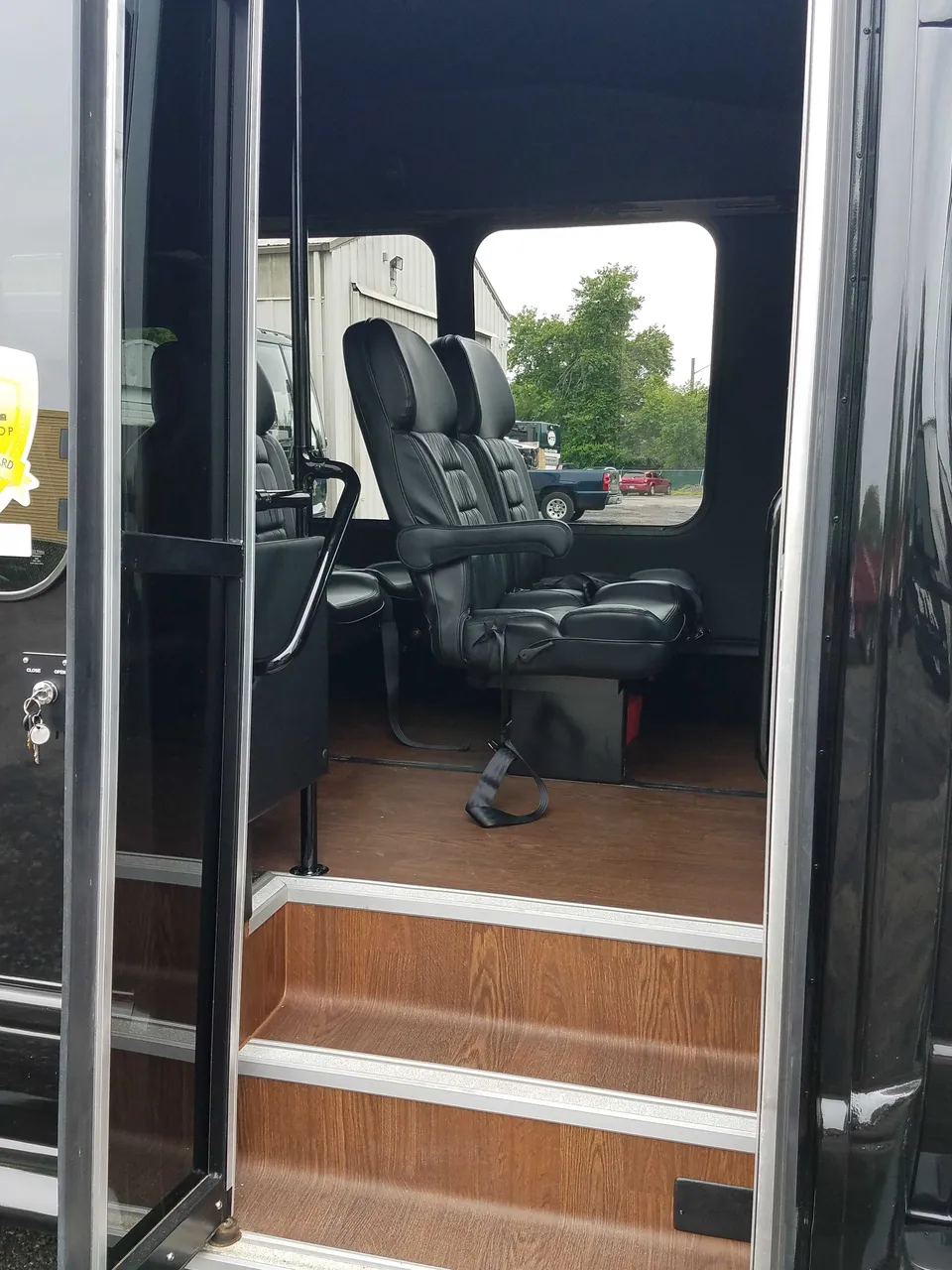 13 Passenger Mini Van cabin view with wood-look flooring