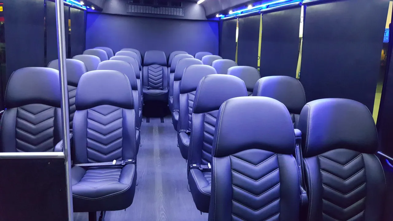 23 Passenger Mini Coach cabin view with window shades and LED accent lighting