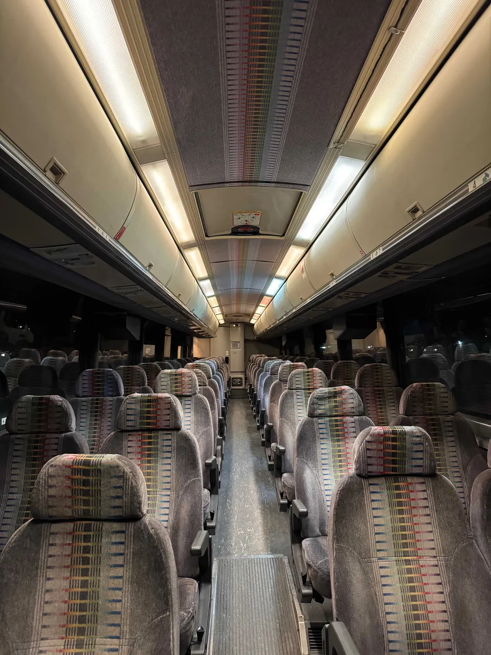 52 Passenger Motor Coach cabin view with overhead parcel racks