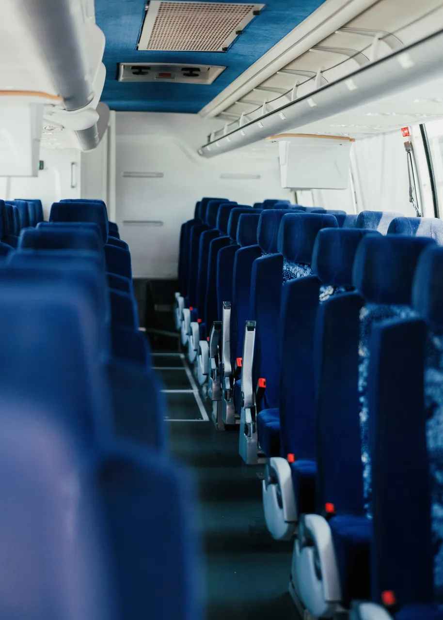 56 Passenger Motor Coach cabin view, angle 5 with overhead parcel racks