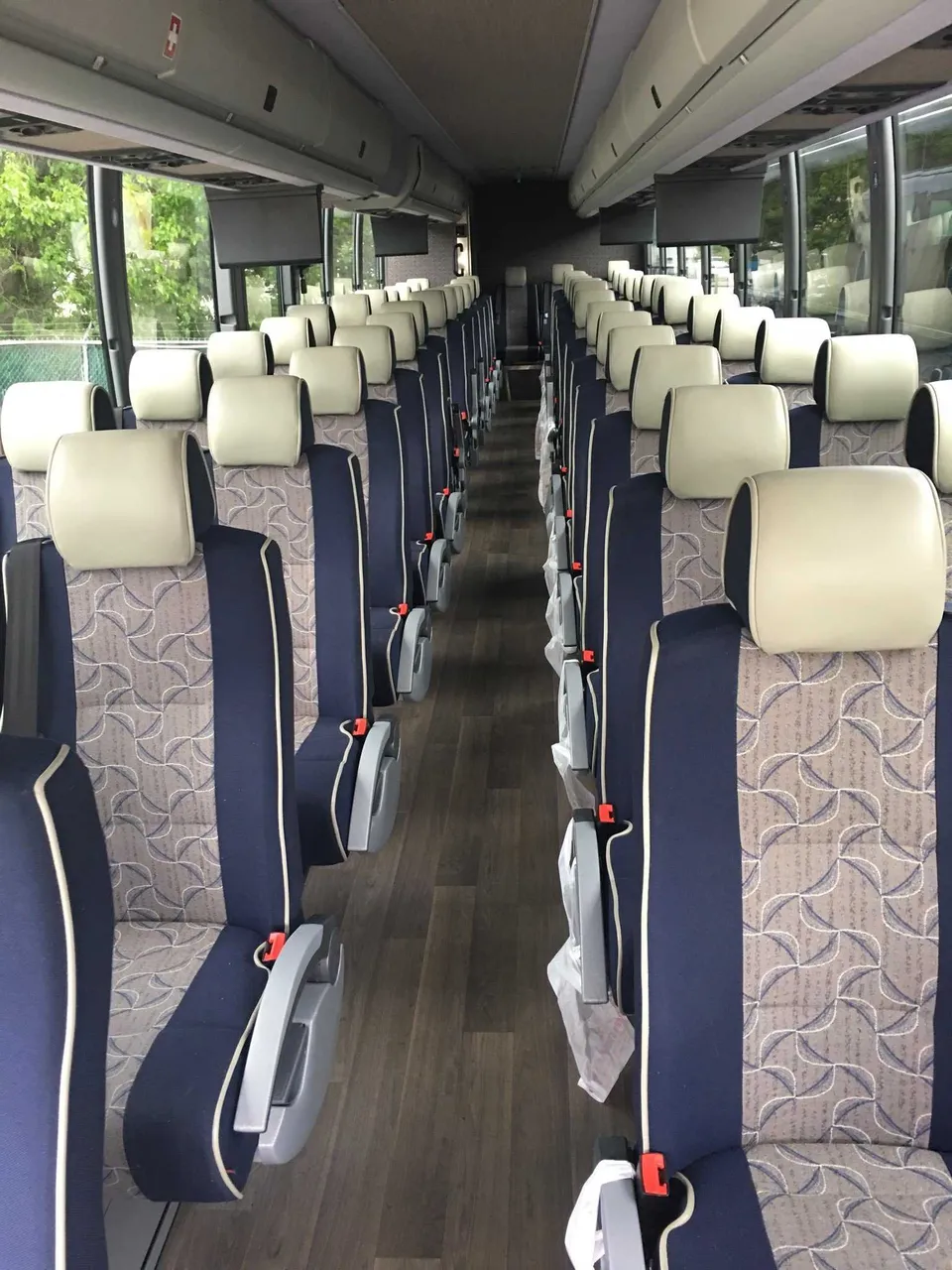 55 Passenger Motor Coach cabin view with overhead parcel racks