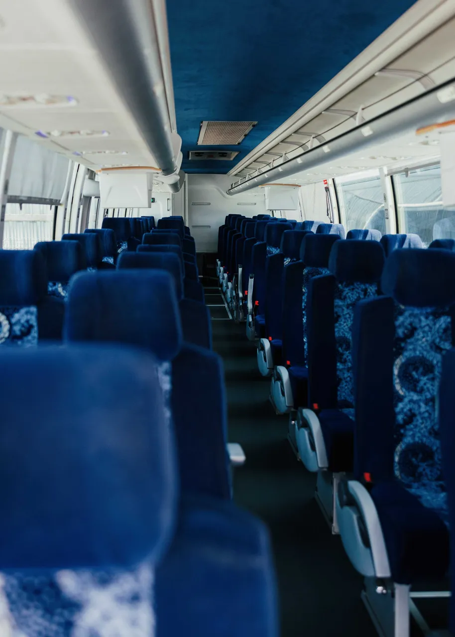 56 Passenger Motor Coach cabin view with overhead parcel racks
