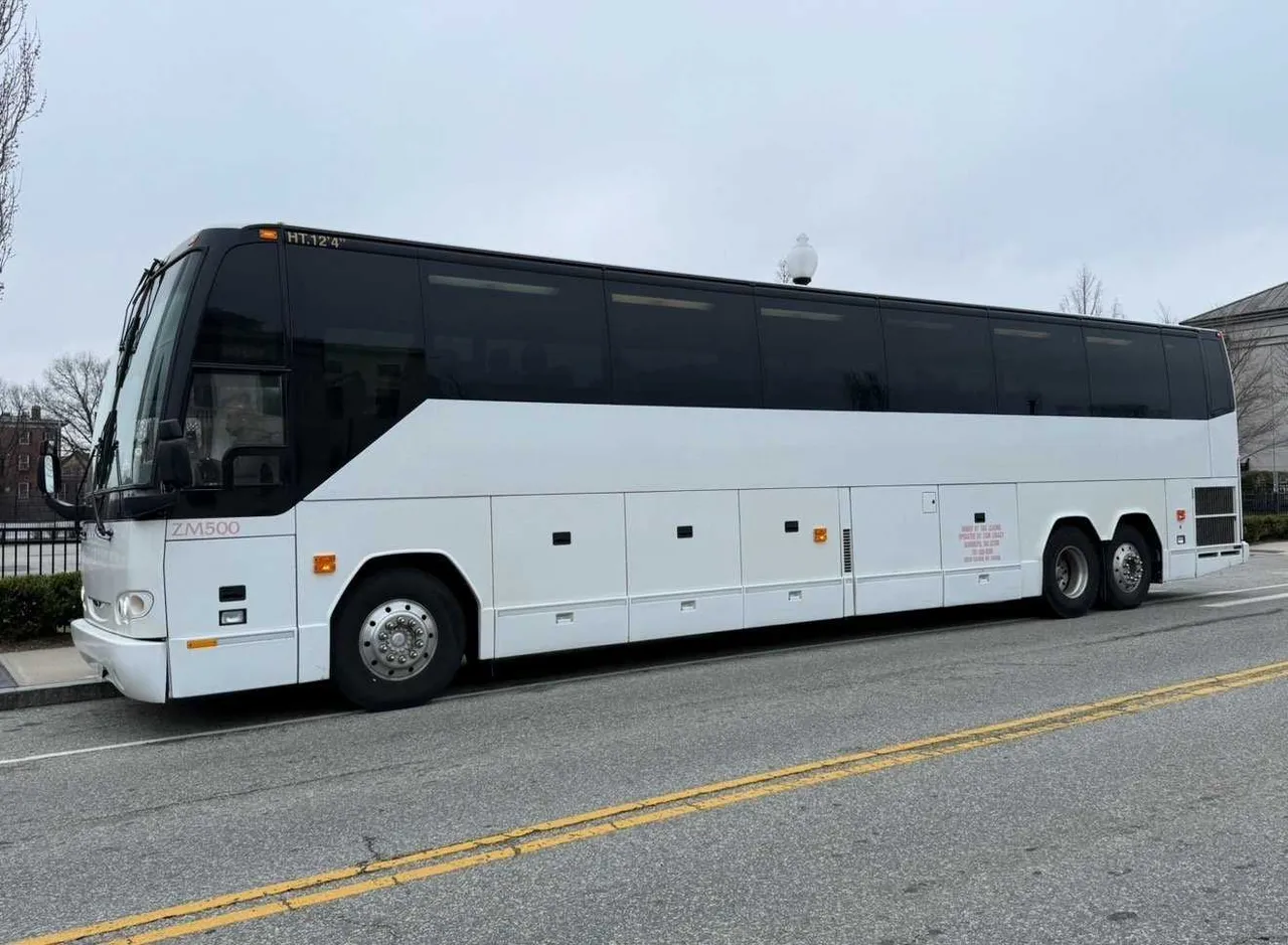 White 55 Passenger Motorcoach exterior angle with tinted windows