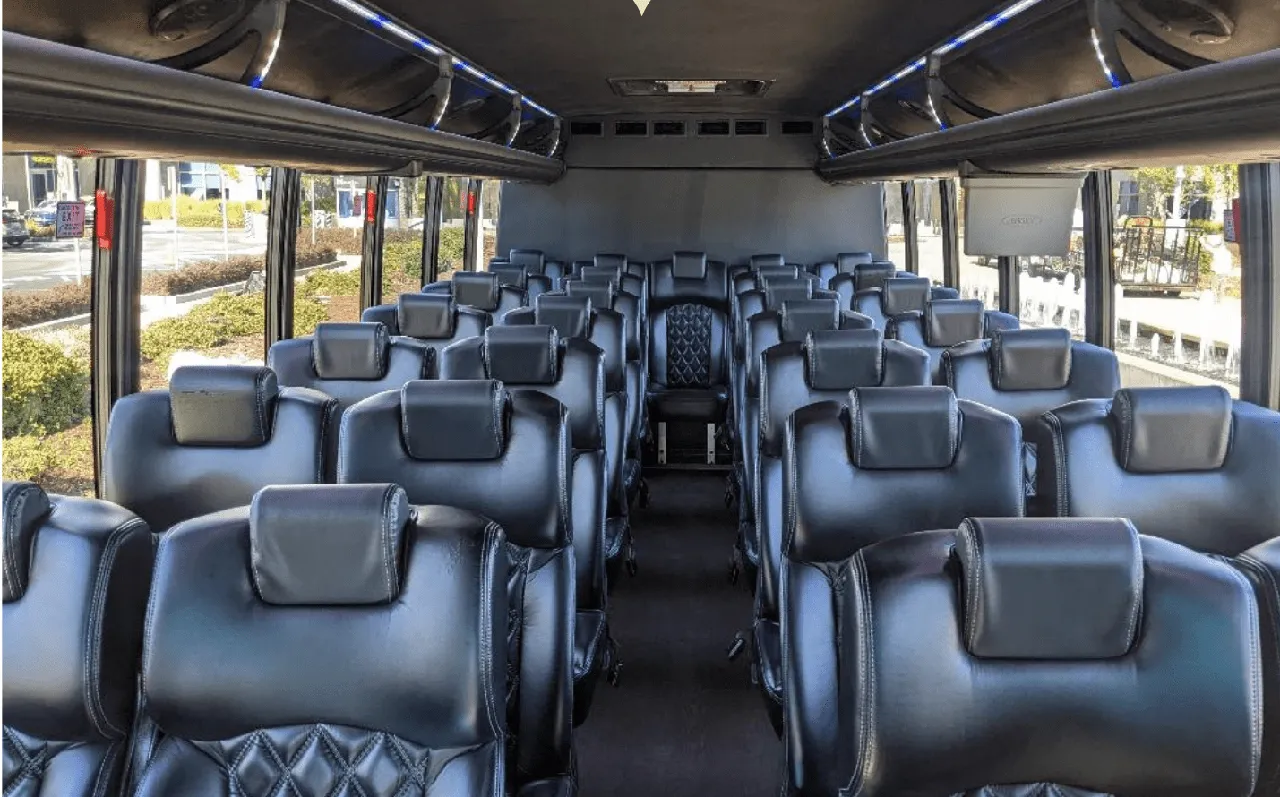 Ford F550 Executive Mini Coach cabin view with LED accent lighting and overhead parcel racks