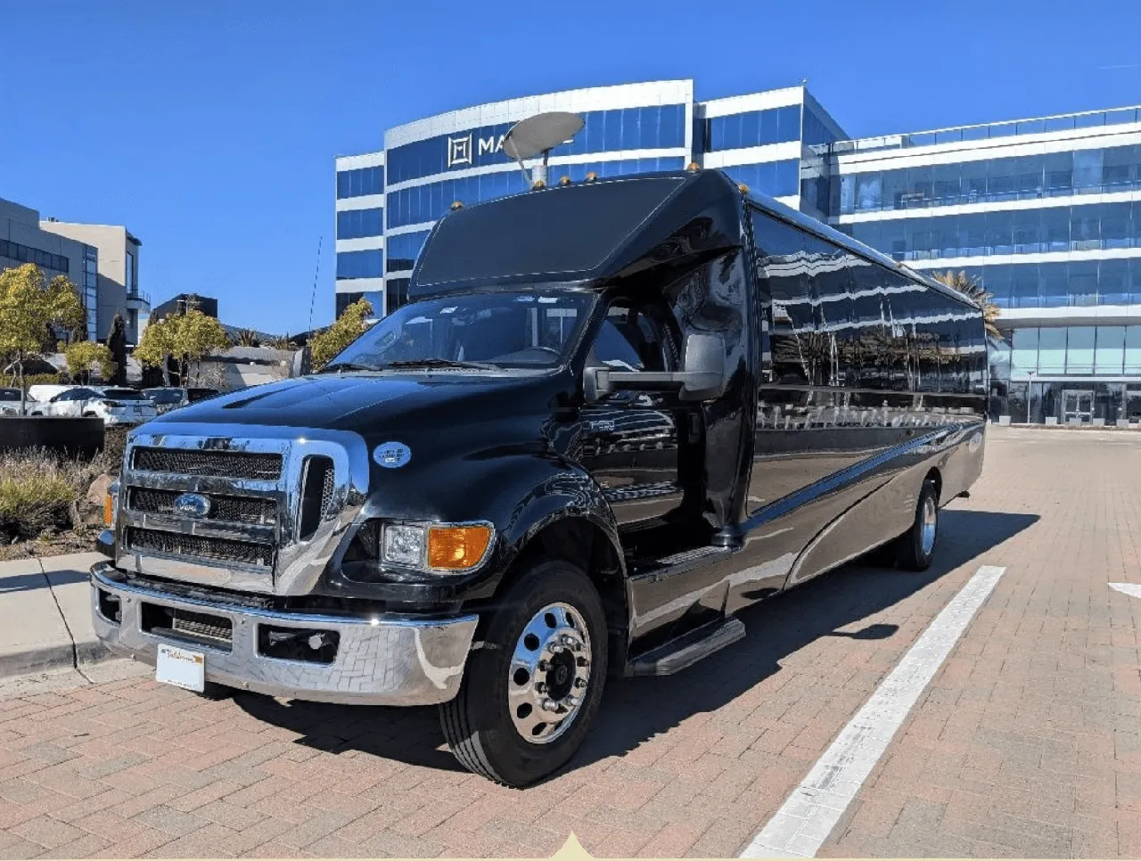 Black Ford F550 Executive Mini Coach with tinted windows