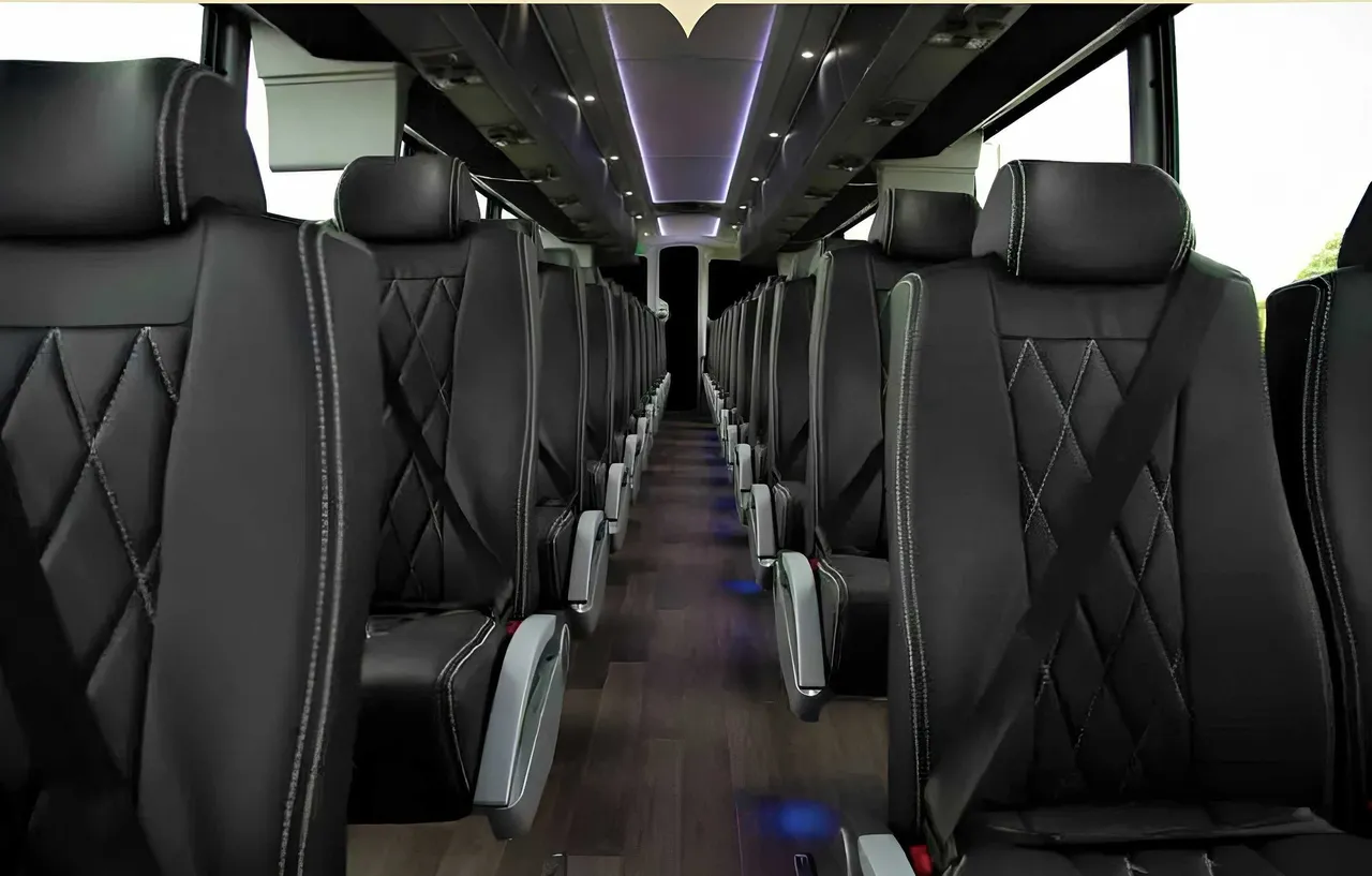 56 Passenger Motorcoach cabin view with LED accent lighting, LED ceiling lighting and passenger seat belts