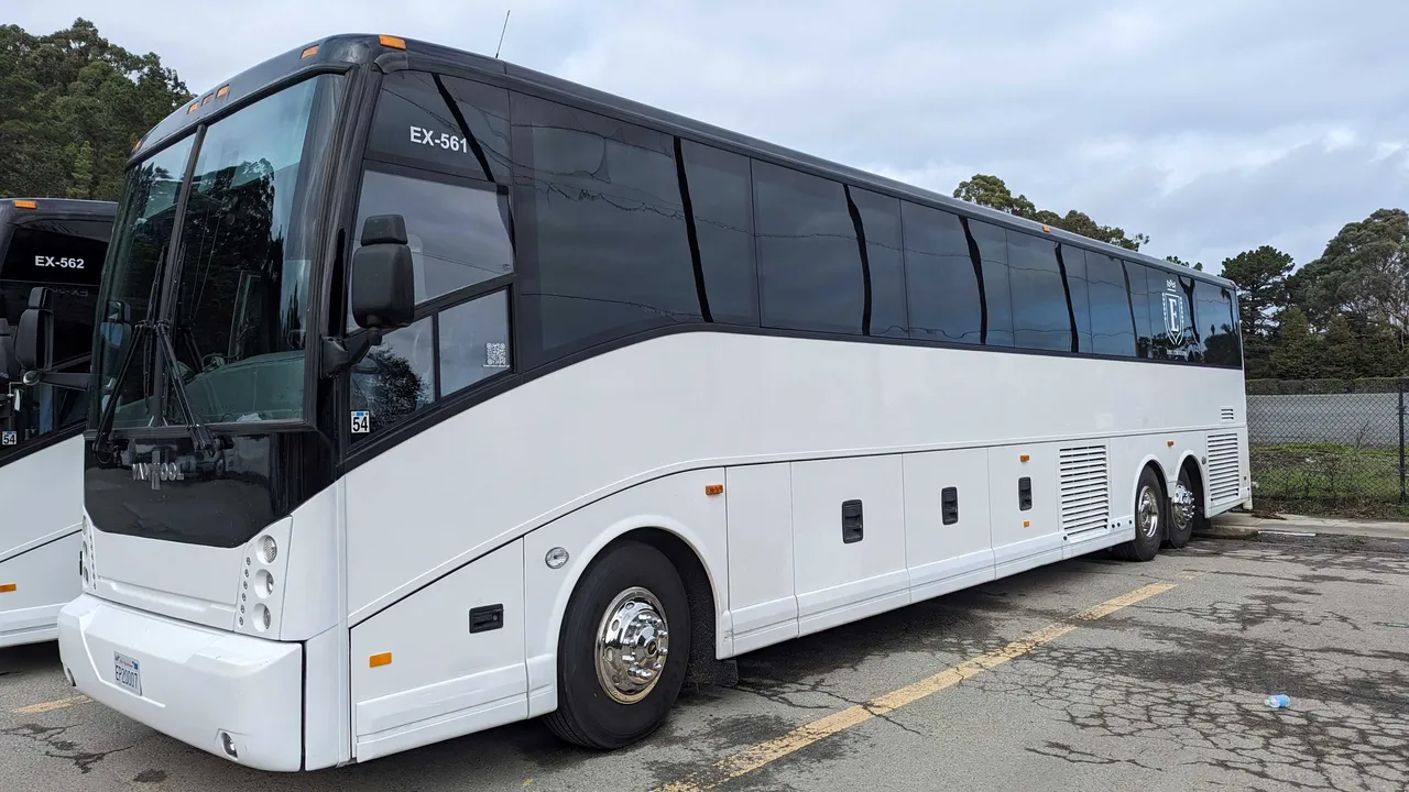 White 56 Passenger Motorcoach with tinted windows