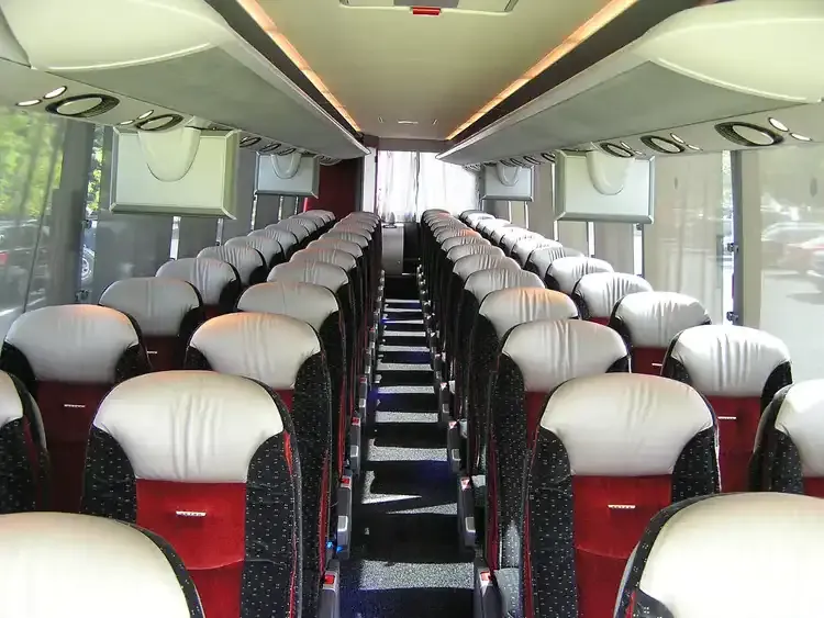 30 Passenger Motorcoach cabin view with individual air vents and overhead parcel racks