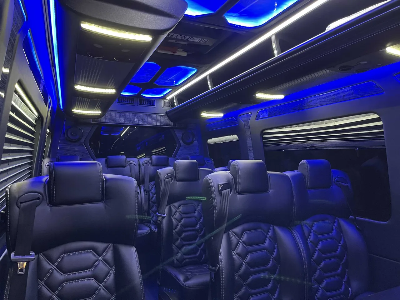 Sprinter VIP Van cabin view with captain's chairs, window shades and LED accent lighting