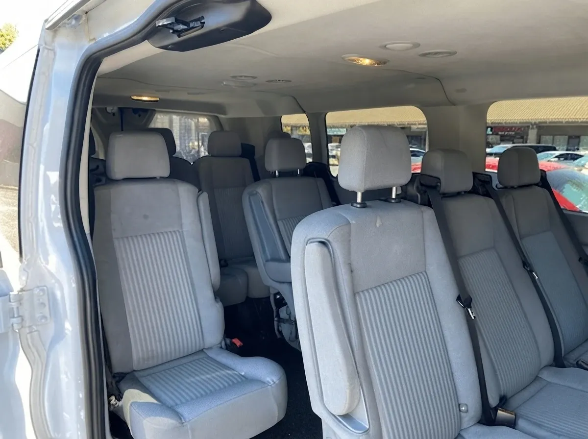 White 10 Passenger Transit Van, angle 2