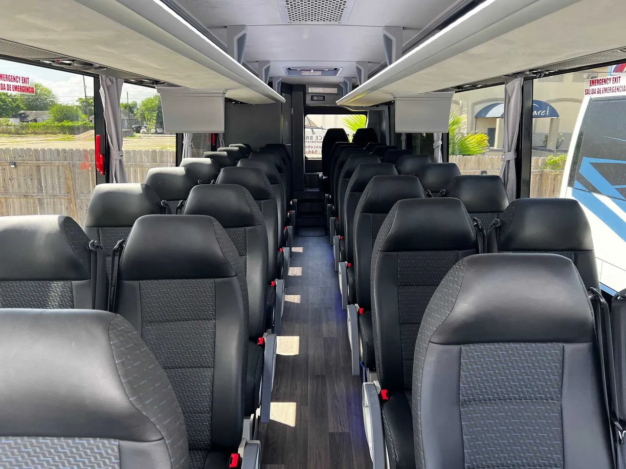 34 Passenger Charter Bus cabin view with window shades and overhead parcel racks