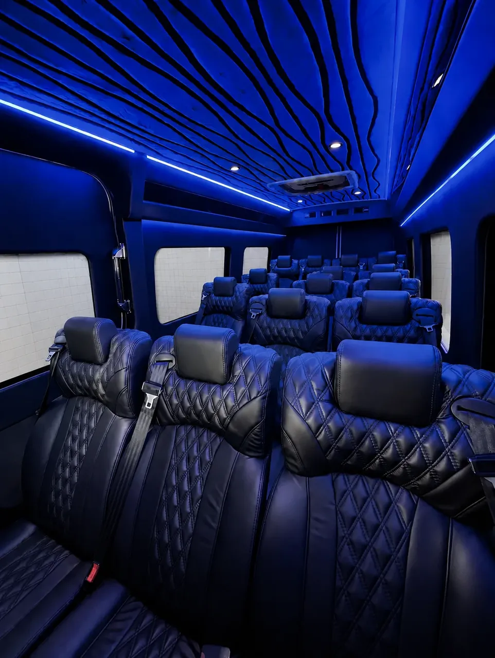White Luxury Sprinter Shuttle Van cabin view with window shades, LED accent lighting and LED ceiling lighting