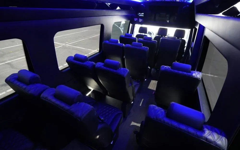 White Luxury Sprinter Shuttle Van cabin view with LED accent lighting